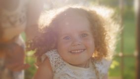 Portrait of beautiful curly girl in sunset light. Happy curly girl