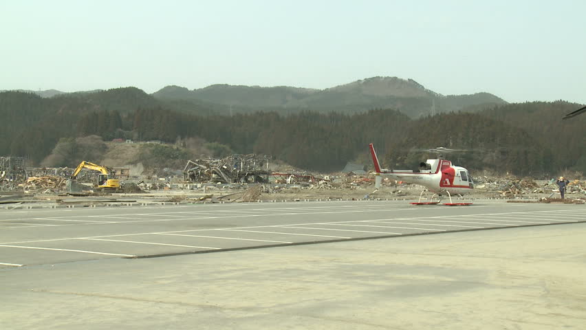 RIKUZENTAKATA, JAPAN - APRIL 1: Helicopter prepares for take off from tsunami