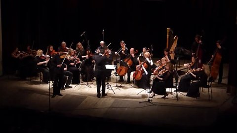 DNIPRO, UKRAINE - JUNE 6, 2016: The famous violinist Eugene Kostritsky and FOUR SEASONS Chamber Orchestra - main conductor Dmitry Logvin perform at the State Russian Drama Theatre