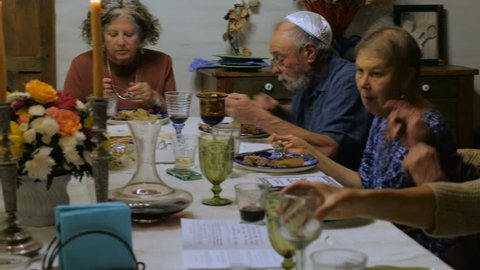 A large group of seniors eating at a dinner party or passover seder