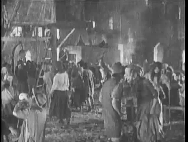 15th century reenactment of man slapping woman in outdoor camp, 1920s