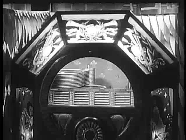Close-up of record dropping in jukebox, 1940s