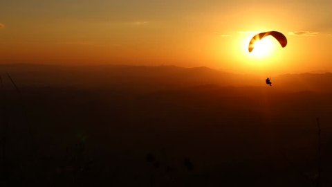 paragliding with beautiful sunset background. 