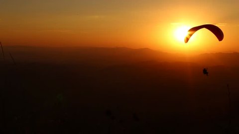 paragliding with beautiful sunset background