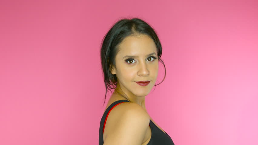 Beautiful girl posing and being happy on bright pink background