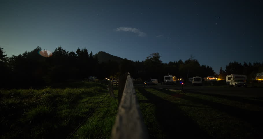 Tongue Point, Washington, USA - starry night with moonlight and moving shadows on the campground with illuminated camper vans - Timelapse without motion - October 2014