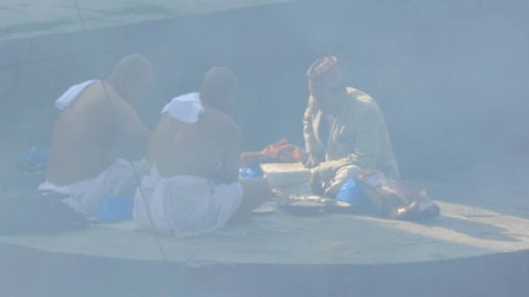 KATHMANDU NEPAL CIRCA APRIL 2016: The Hindu ritual of the cremation in Pashupatinath Kathmandu.Monk and family praying for a soul of dead person