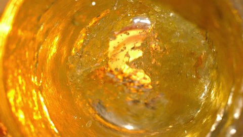Top View of Beer Pouring Into a Glass in Slow Motion at 1500 fps Macro With Splashes and Drops