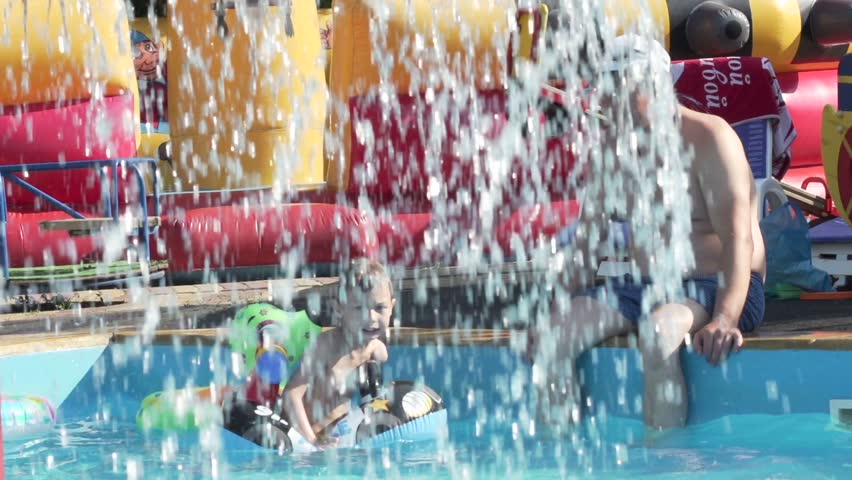 child with father in the summer pool,slow motion