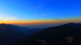 Sunrise over mountains Nature background aerial video 4k. Sunset Sunshine in Himalayas Nepal peaks. Sun rises on clear sky.