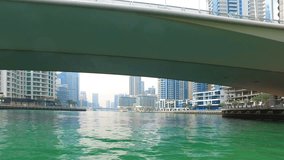 Sailing on Boat at Dubai Jumeira Marina video 4k. Skyscrapers modern buildings Travel tourism Real Estate business in United Arab Emirates 
