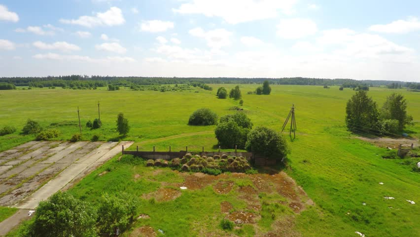 Abandoned destroyed old barn house. Broken roof. Low altitude flight. Aerial footage. Summer nature background.