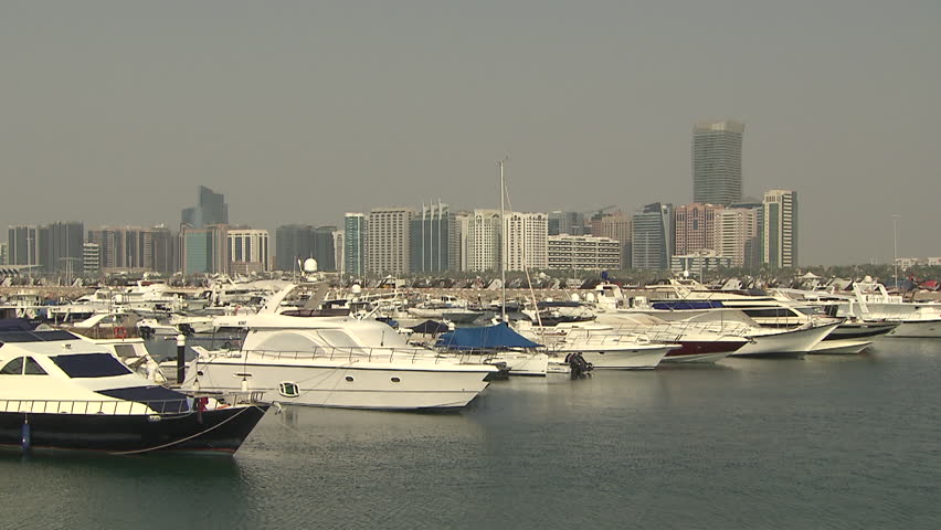 Marina, Abu Dhabi. Pan-left across a view of yachts in the marina and the Abu Dhabi skyline as seen from the Marina Mall complex. (Abu Dhabi, UAE - 2013)