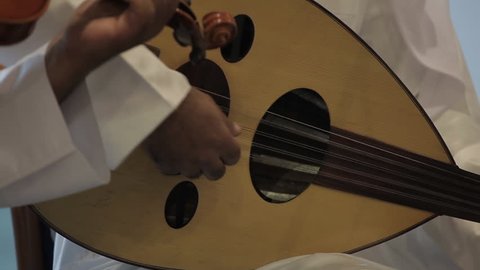 Musical Instruments. CU on the hand of a musician playing the oud or lute, a type of Middle Eastern guitar. (Bahrain - 2012)
