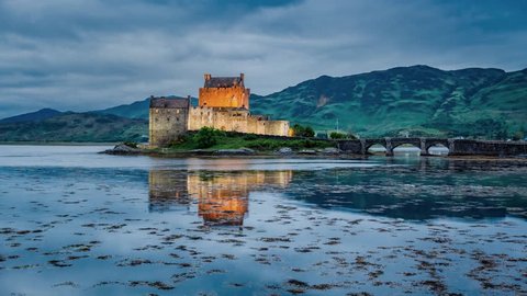 Beautiful sunset over the lake at Eilean Donan Castle in Scotland, 4k, timelapse