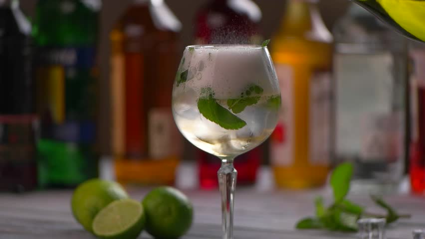 Foam in glass with cocktail. Beverage with mint in wineglass. Hugo cocktail with quality champagne. Drink served at the party. Royalty-Free Stock Footage #17539357