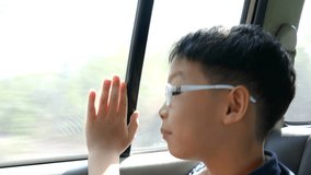 Young asian boy traveling in a car