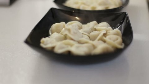 Russian national food dumplings arrange on plates, tableware