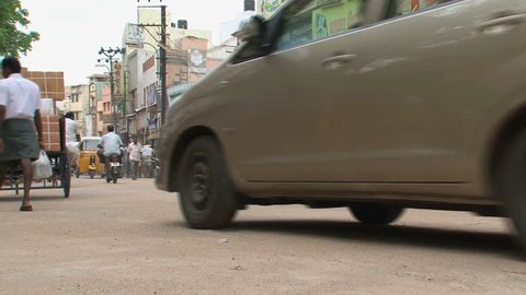 INDIA - CIRCA APRIL, 2011:  Busy Indian street with Rickshaws and motorbikes.