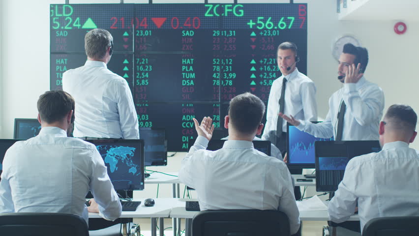 Group of Stockbrockers Actively Working at Stock Exchange. Shot on RED Cinema Camera in 4K (UHD). Royalty-Free Stock Footage #17554399