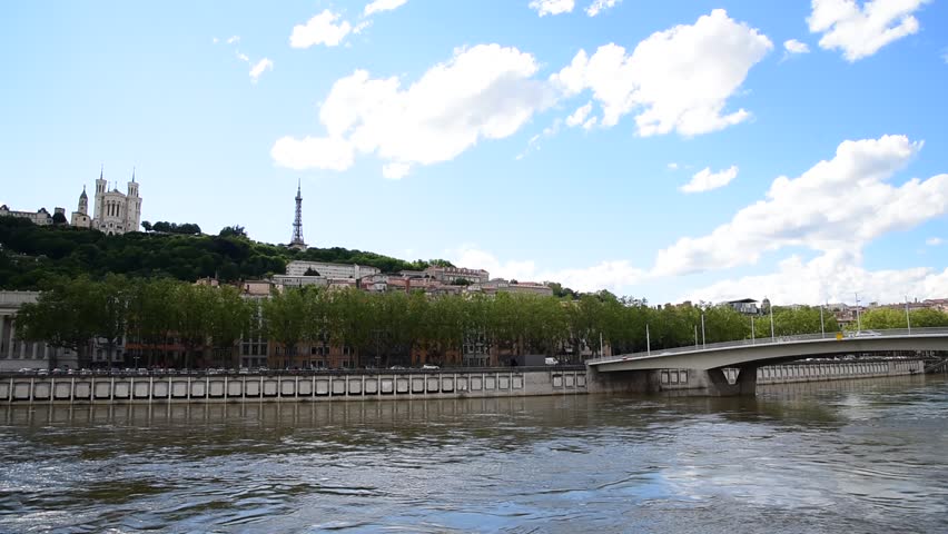 Soane river view with cathedrals Saint-Georges and Fourviere under blue sky white cloud in Lyon, France.