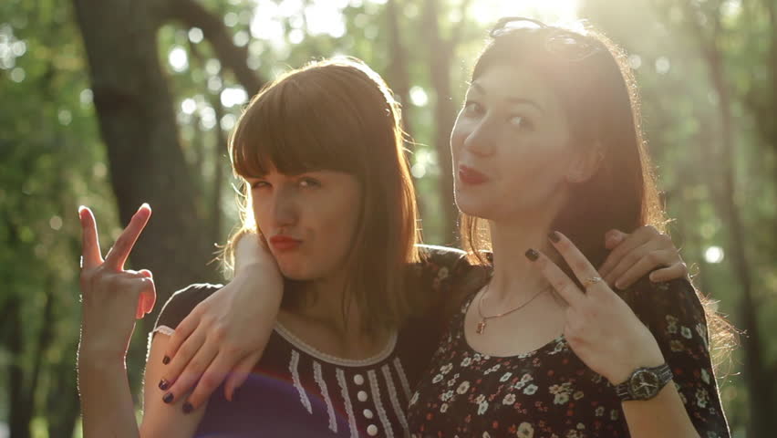 Beautiful girl doing funny selfie in the sun in the park