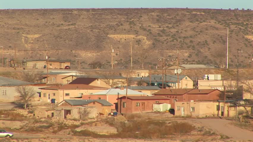 Overview of homes in Laguna Pueblo village with mountains in background, New Mexico USA