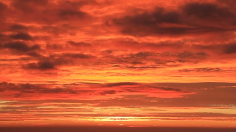 Tilt-up shot of orange sunrise sky in the morning.