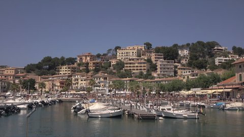 PORT DE SOLLER, MALLORCA/SPAIN - APRIL 28, 2016: Pan across marina, waterfront and promenade of Port of Soller. The town is an important holiday resort in the Balearic Islands.