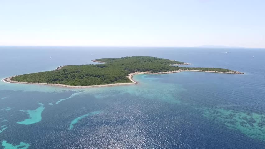 Aerial view of cozy mediterranean island.Blue lagoon, island paradise. Adriatic Sea of Croatia, Korcula, popular touristic destination.Proizd.Clear sea water | Shutterstock HD Video #17572600
