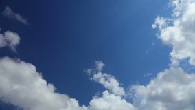 Beautiful white fluffy clouds on the blue clear sky, bright sunny day, good summer weather, fast motion, time lapse. Full HD Video 1920x1080