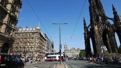EDINBURGH - MAY 29, 2016: Traffic at Princes Street garden with Scott Monument full of people in a sunny summer day, on 29th May 2016
