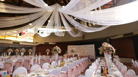 Interior of a wedding hall decoration ready for guests.Beautiful room for ceremonies and weddings.Wedding concept.Luxury stylish wedding reception purple decorations expensive hall