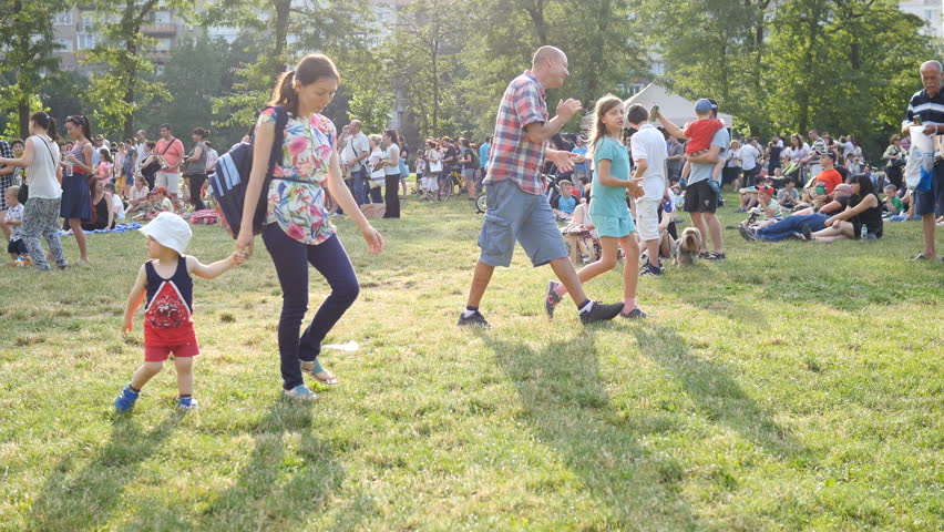 SOFIA, BULGARIA - JUN 22, 2016: Free open air concert festival. Family mother with kid walk rest on park picnic festival waiting for open air concert | Shutterstock HD Video #17604943