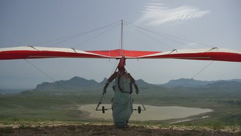 Hang glider takeoff on a background of lake