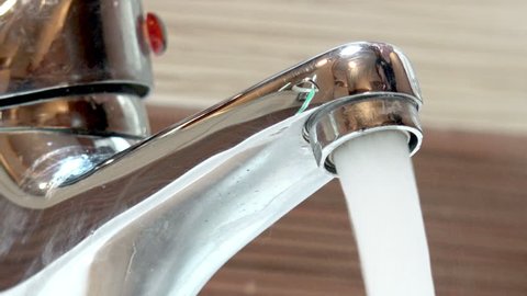 Turning off a Tap with Hot Ruunning Water, closeup