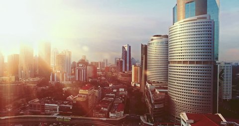 Cinematic style. Aerial view of Kuala Lumpur during sunrise with the sun in between of the Kuala Lumpur City Centre building