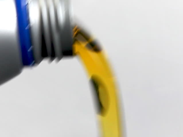 Motor Oil Pouring from Plastic Bottle