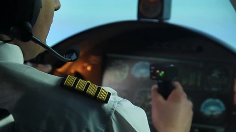 Airline pilot trying to prevent accident, plane shaking in turbulence, danger. Aircraft captain professionally operating jet in stormy weather, stressful occupation. Navigation, unexpected problem
