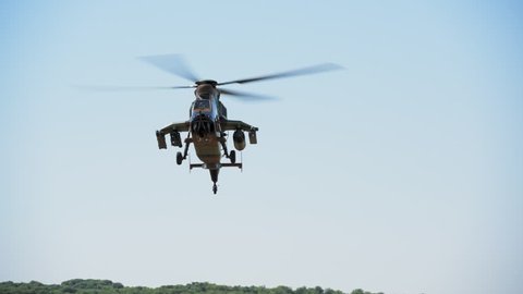MADRID, SPAIN - JUNE 23, 2016: A fully armed Spanish Army Eurocopter Tiger helicopter approaches and lands on open field (part of 50th anniversary of the unit). With ambient sound. ProRes HQ