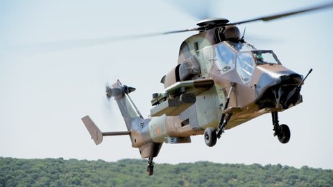 MADRID, SPAIN - JUNE 23, 2016: A fully armed Spanish Army Eurocopter Tiger helicopter approaches fast and lands on open field (part of 50th anniversary of the unit). With ambient sound. ProRes HQ