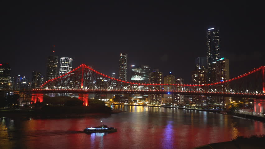 night shot of a ferry and brisbane