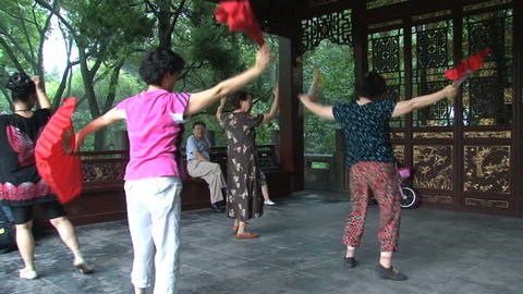 SHANGHAI - CIRCA AUGUST, 2011: Women performing traditional dance outside.