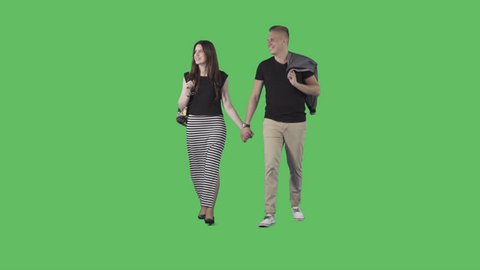 Young male and attractive girl in summer clothes are walking holding hands. Moving at the camera. Camera is static. Lens 85 mm. Footage with alpha channel. File format - .mov, codec PNG+Alpha