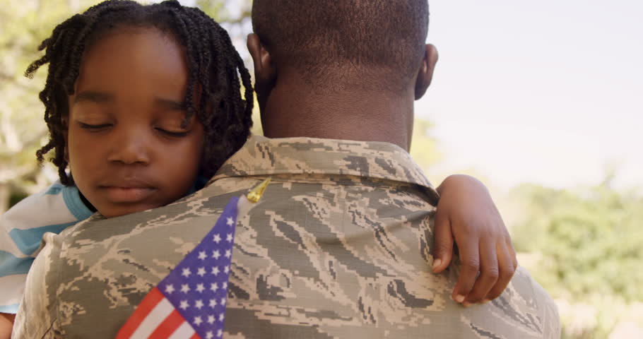 American soldier is hugging his son in a park  Royalty-Free Stock Footage #17637433