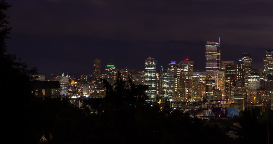 Seattle, Washington, USA - illuminated skyline of Seattle with Space needle as seen from Kerry Park at night with moving clouds - Timelapse with motion and zoom out - August 2013