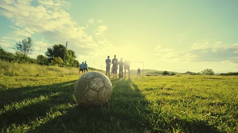Penalties on the pitch. Rural white football young boys. Slow motion.