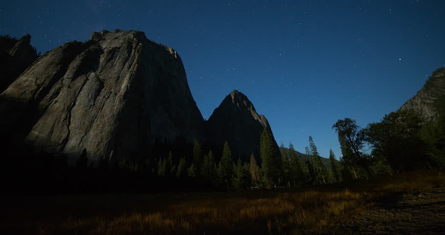 Yosemite National Park, California, USA - view of Yosemite valley with Cathedral Rocks from El Capitan Drive at night with stars and moonlight - Timelapse with pan right to left - August 2013