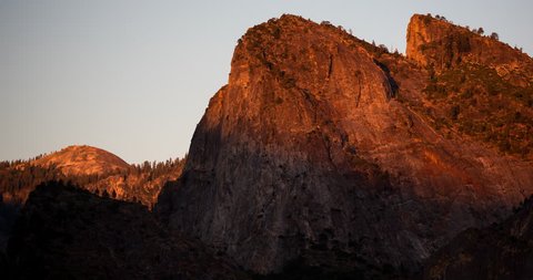 Yosemite National Park, California, USA - view of Cathedral Rocks from Tunnel View at sunset with moving shadows - Timelapse with pan left to right - August 2013