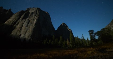 Yosemite National Park, California, USA - view of Yosemite valley with Cathedral Rocks from El Capitan Drive  in the valley at night with stars and moonlight - Timelapse with zoom out - August 2013